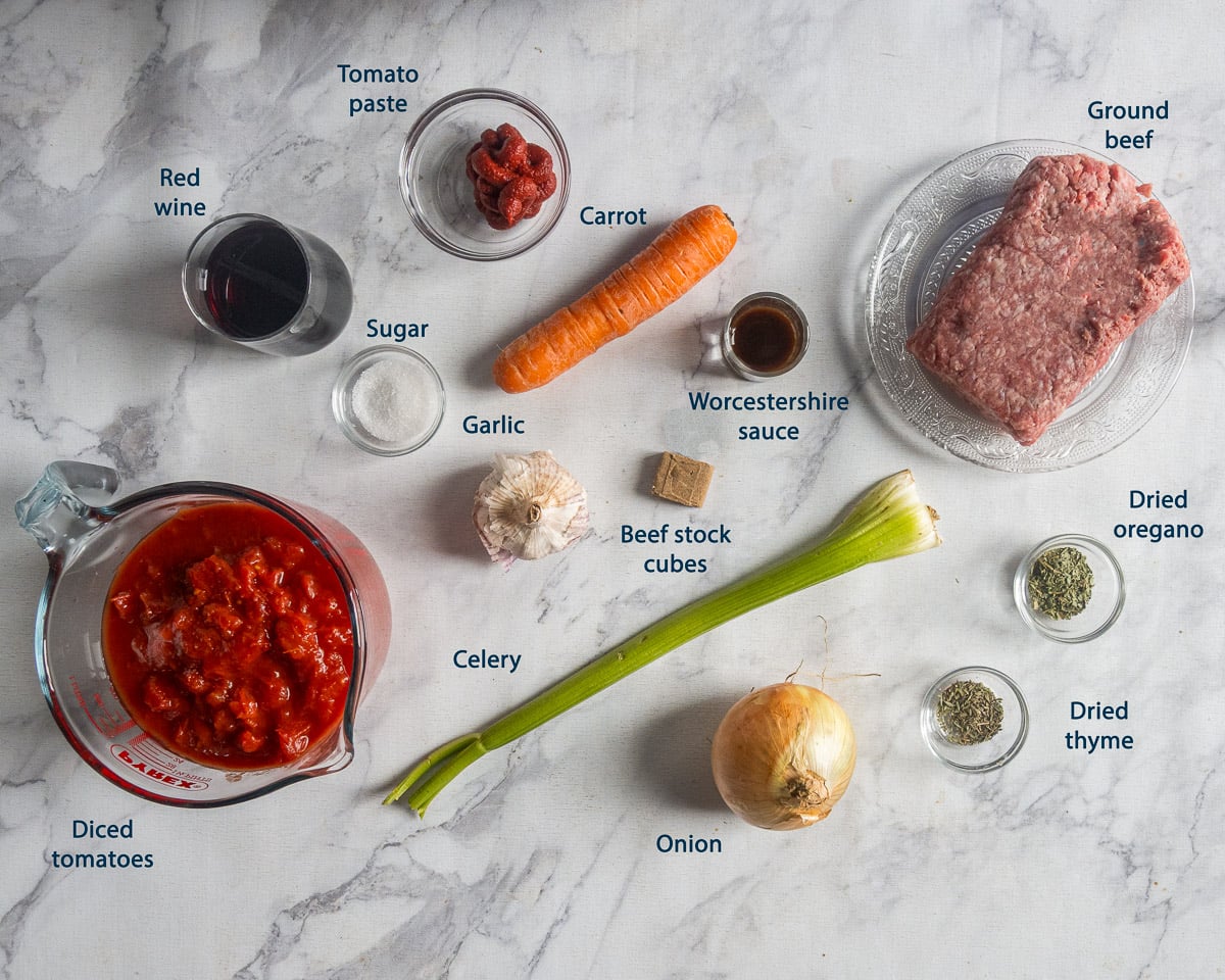 Lasagna sauce ingredients, including ground beef, diced tomatoes, carrot, and red wine, with English labels.