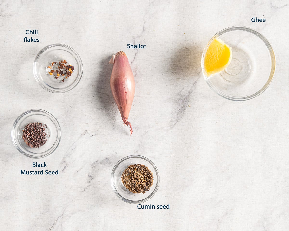 Ghee, shallot, chili flakes, black mustard seeds, and cumin seeds for tadka, with English labels.